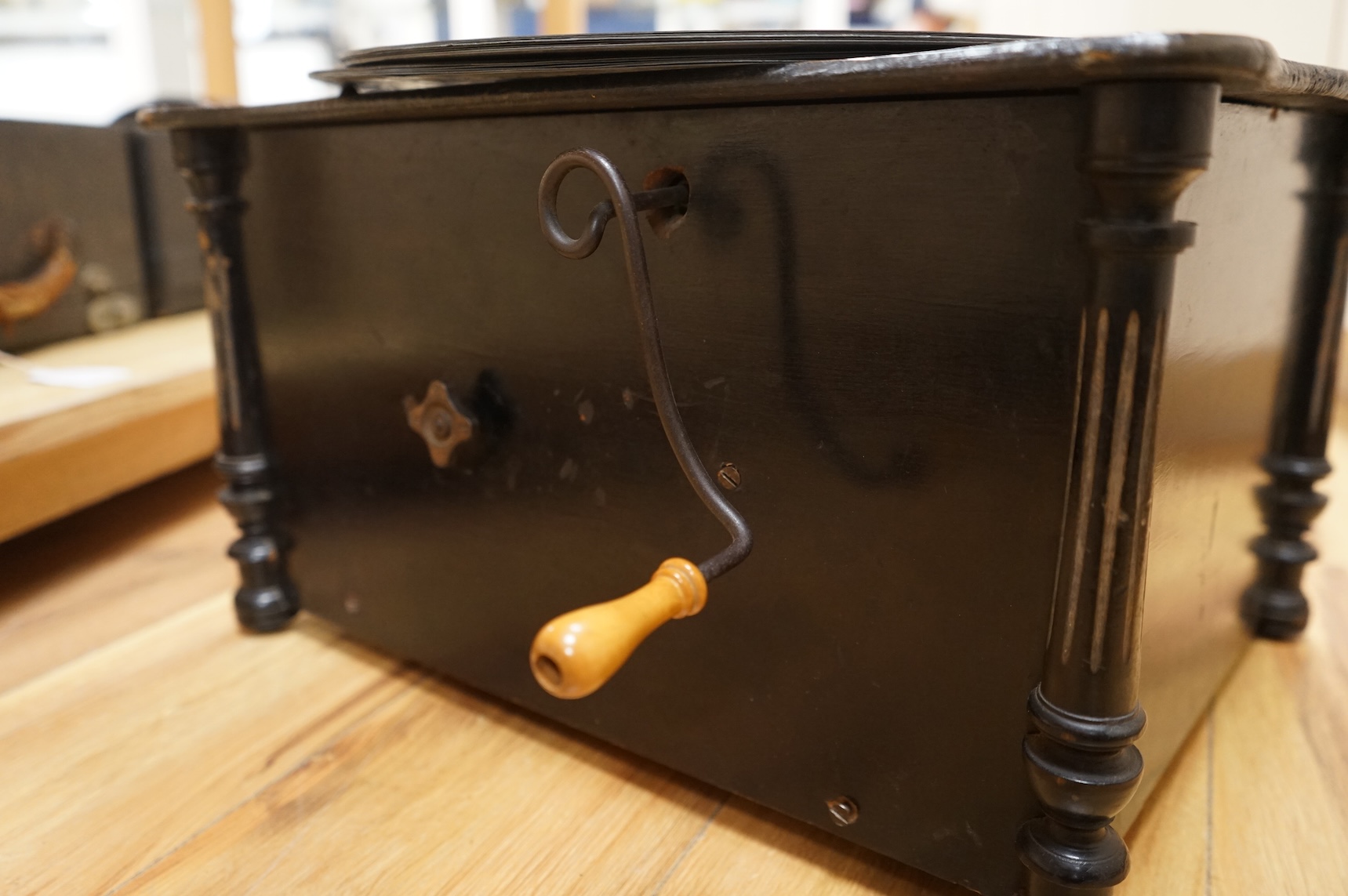 An early 20th century Organette Phoenix in an ebonised case, together with a selection of nineteen related and unrelated discs in three different sizes; five 37cm diameter discs, three 33.3cm diameter discs and eleven 31